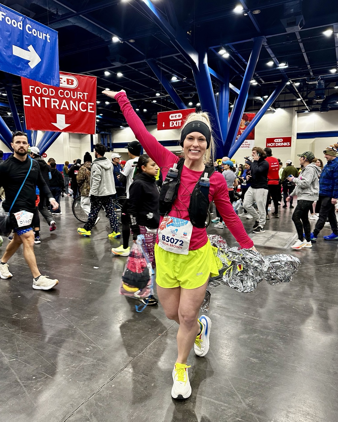 Jena Brown smiling after finishing the 2025 Houston Marathon in bright running gear